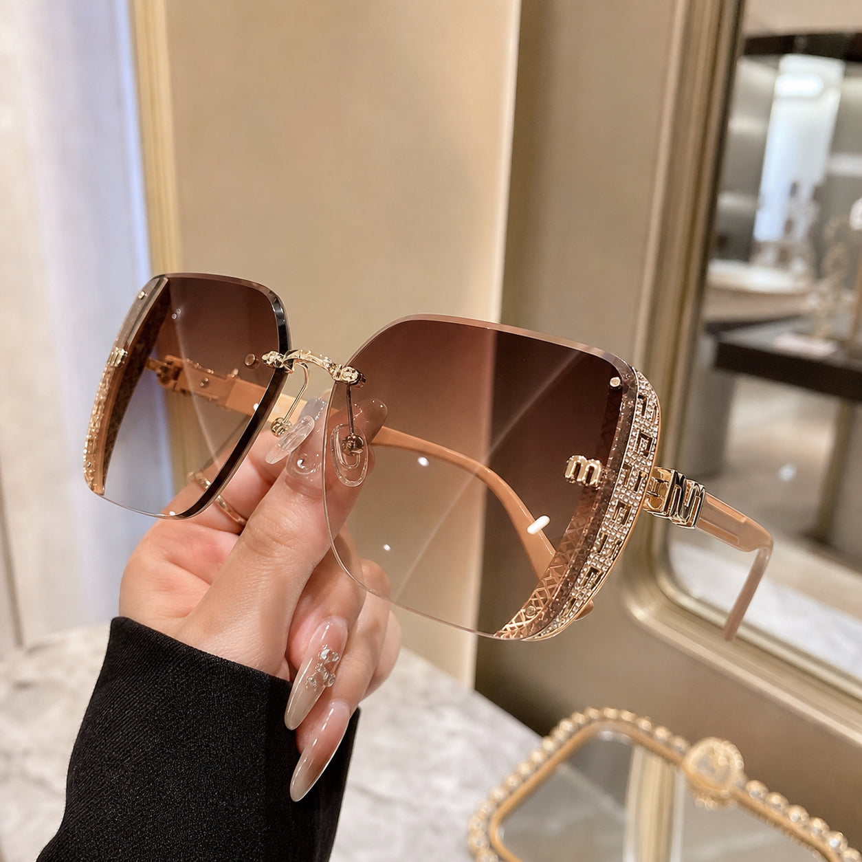Handheld lifestyle photo of brown gold sunglasses
